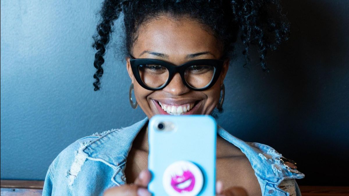 a person wearing glasses taking a selfie