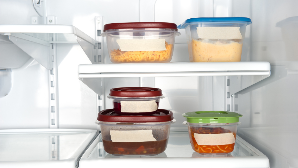 an open refrigerator filled with food in Tupperware boxes