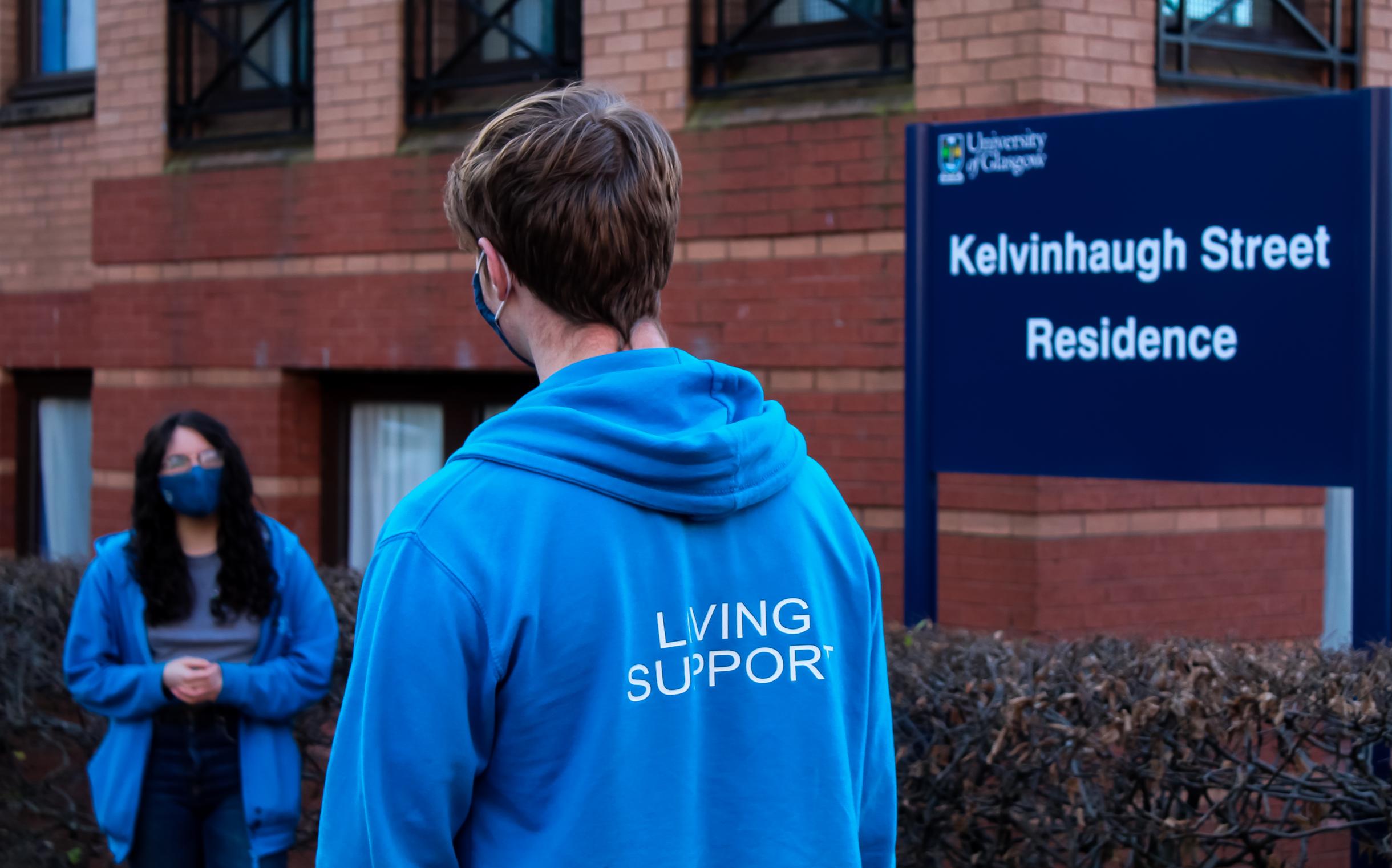 Two Living Support Assistants chatting socially distanced