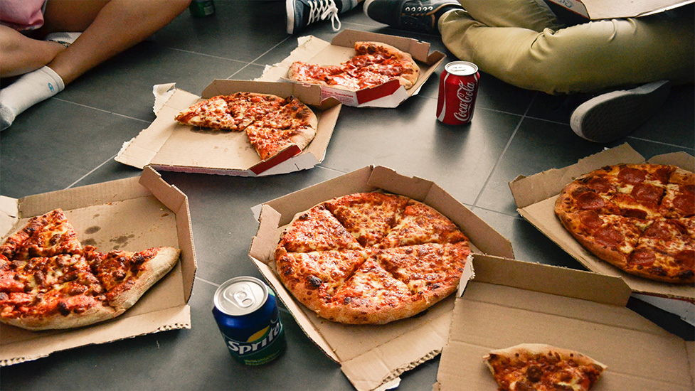 a box filled with different types of pizza sitting on top of a table