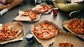 a box filled with different types of pizza sitting on top of a table