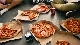 a box filled with different types of pizza sitting on top of a table