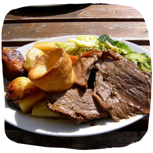 a plate with a roast dinner on a table