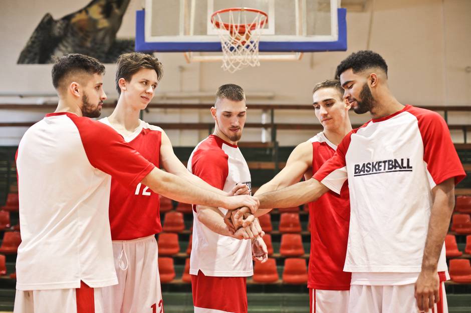 a group of people standing on a basketball court