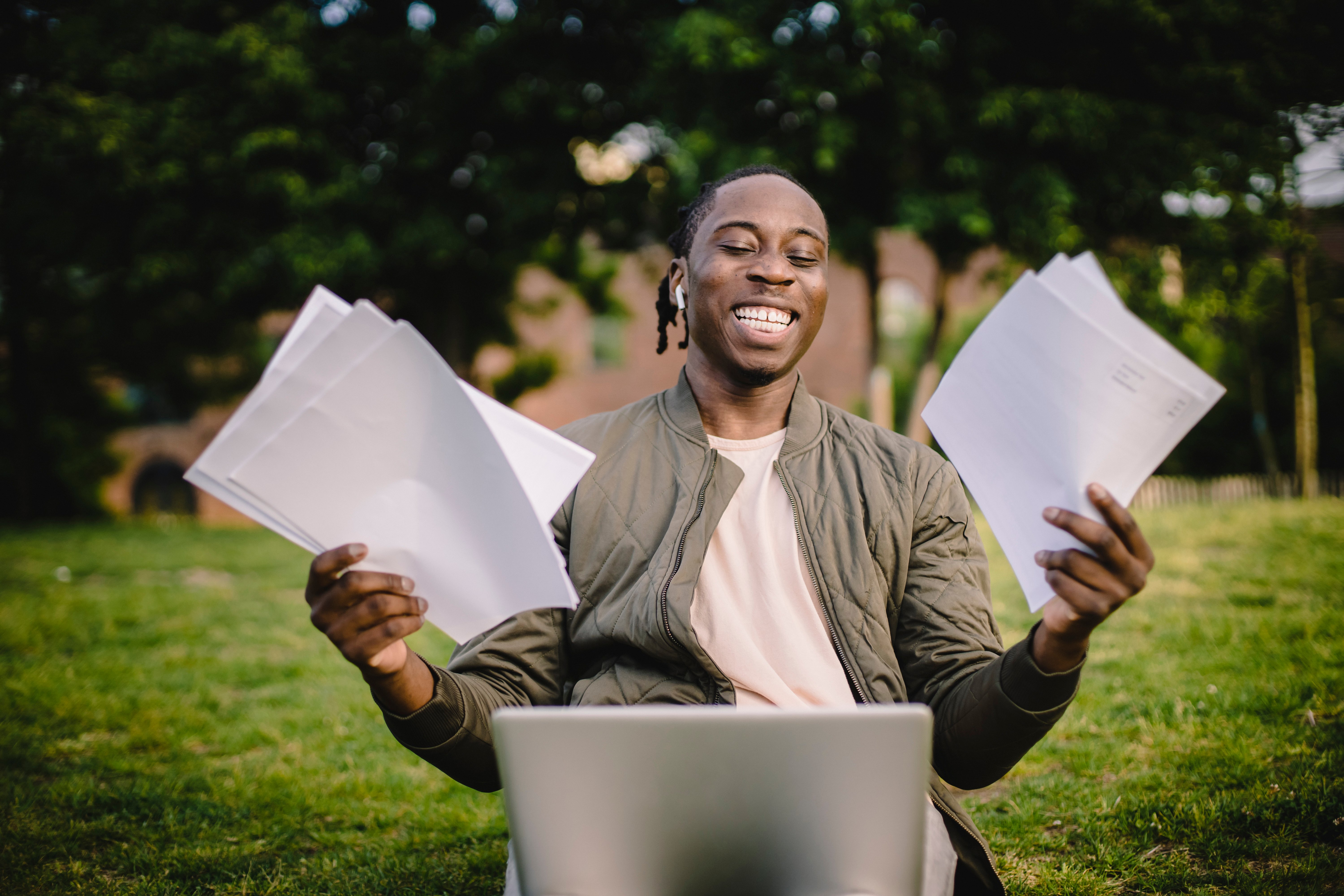 a person holding pieces of paper smiling