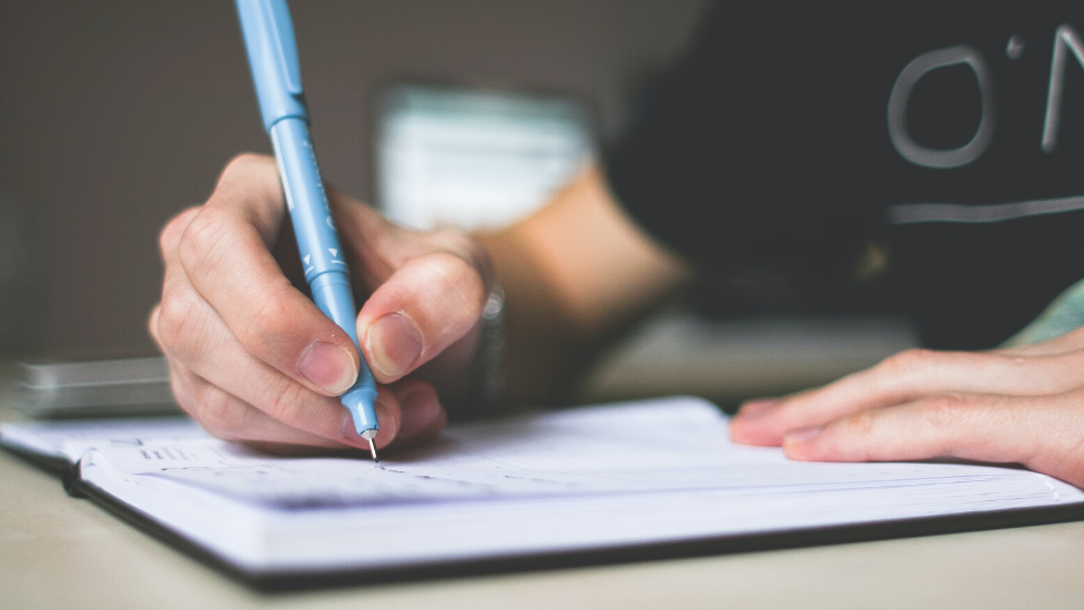 a person writing a note