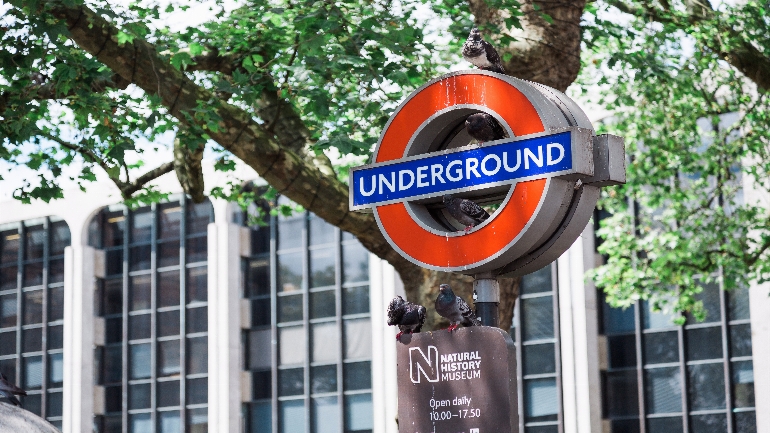 Building with tube sign in front of it.