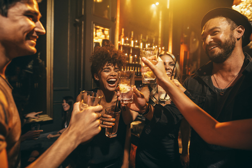 a group of people holding wine glasses