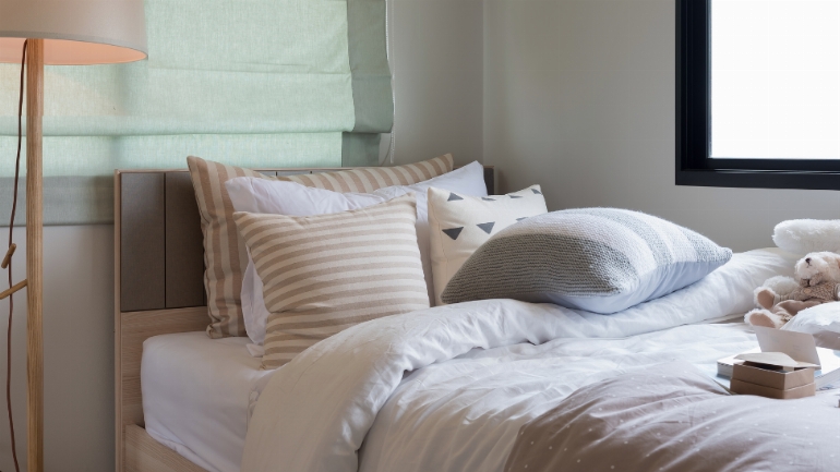 a bed with cushions on it