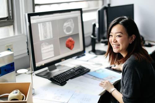 a woman standing in front of a computer