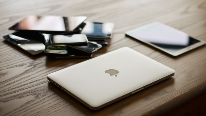 a laptop computer sitting on top of a wooden table