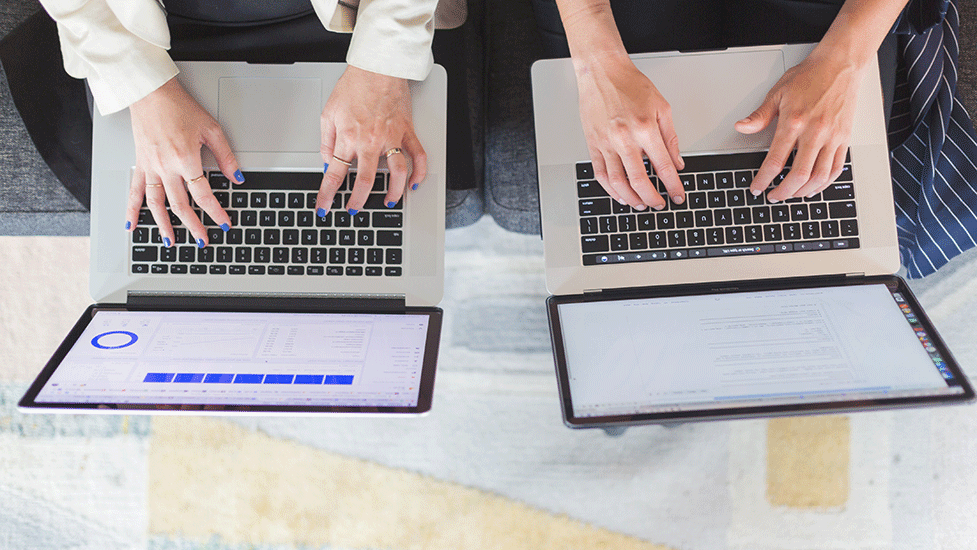 a group of people using a laptop computer