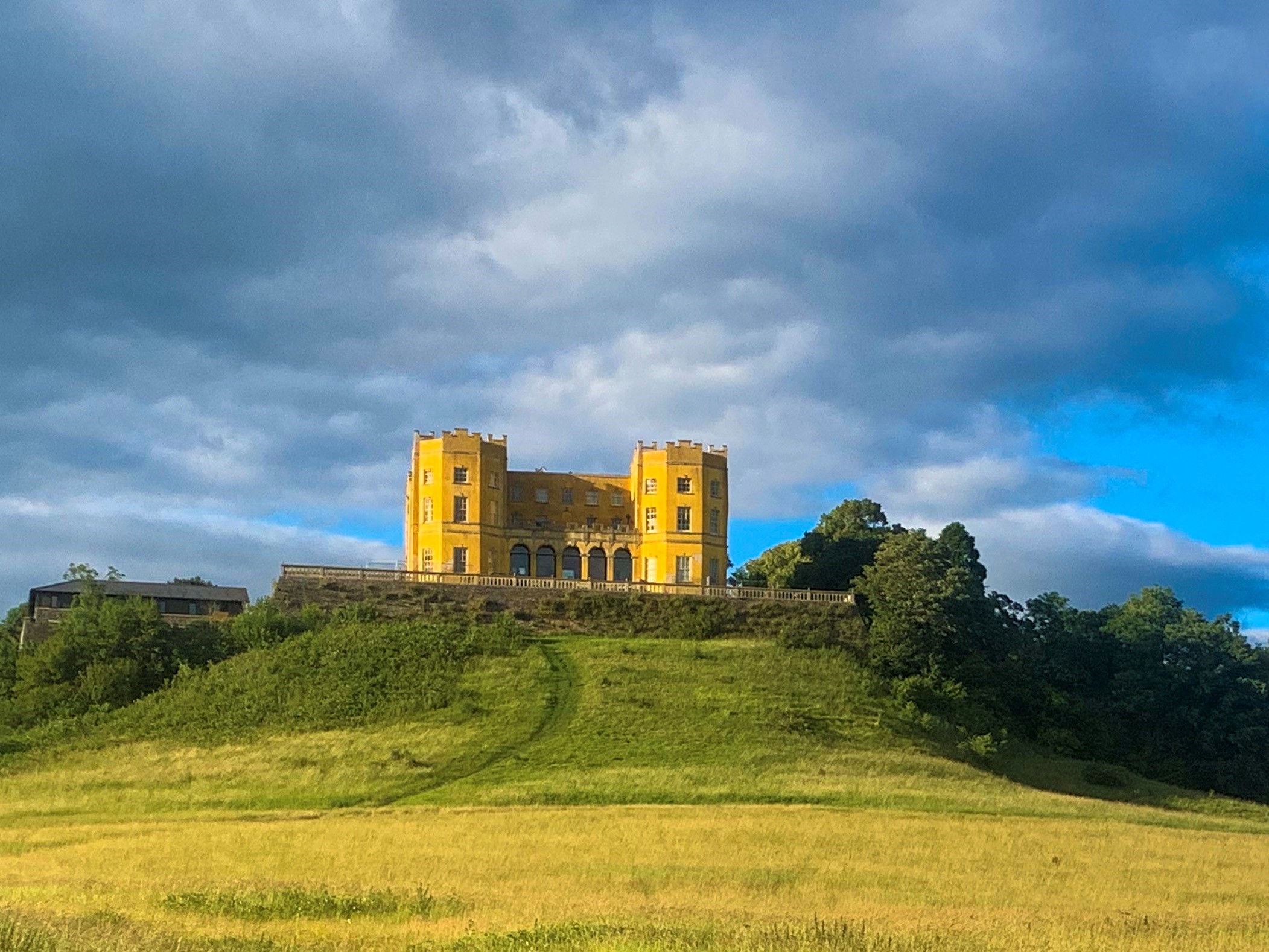 a castle on top of a lush green field