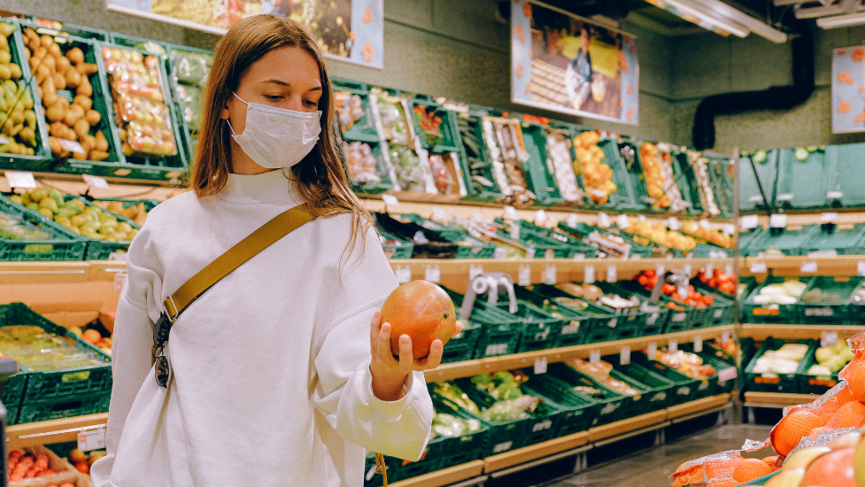 a person wearing a mask in a supermarket