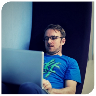 a man sitting in front of a computer screen