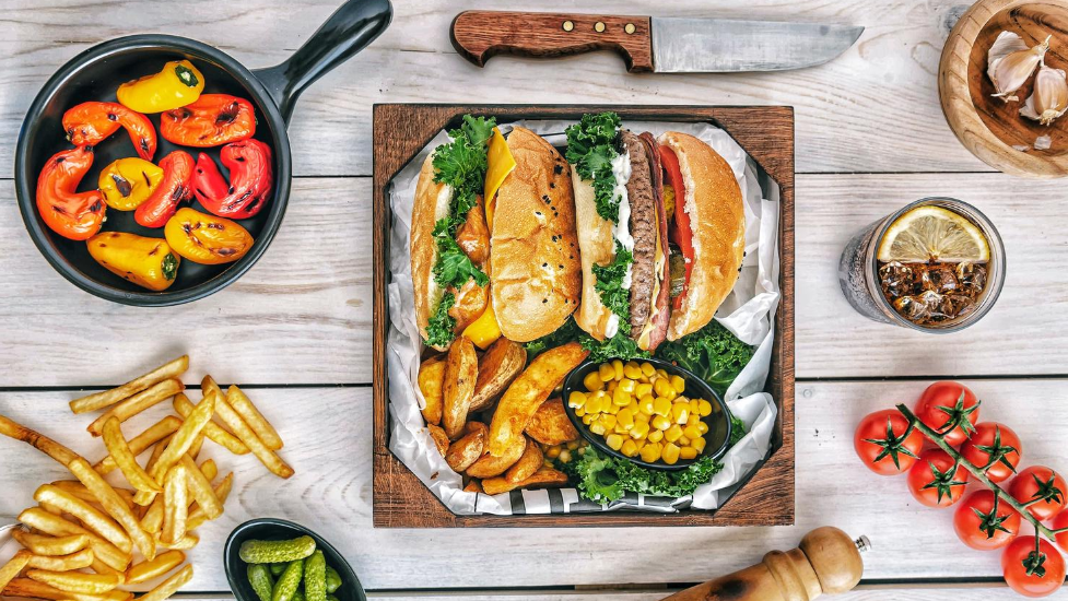 a bunch of different types of food on a wooden table