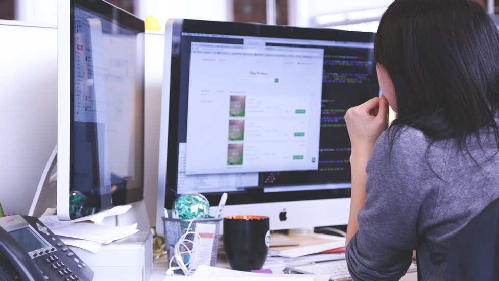 a person standing in front of a computer