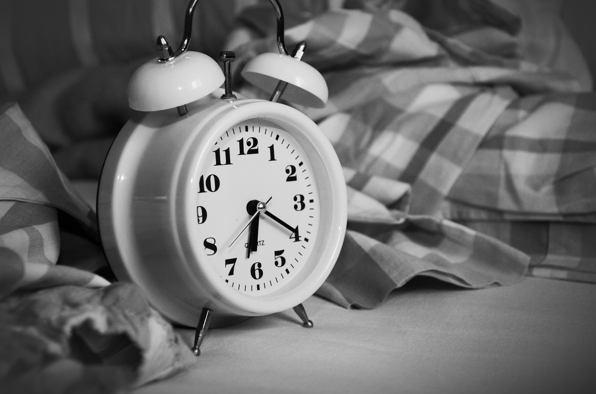 a clock sitting on top of a bed