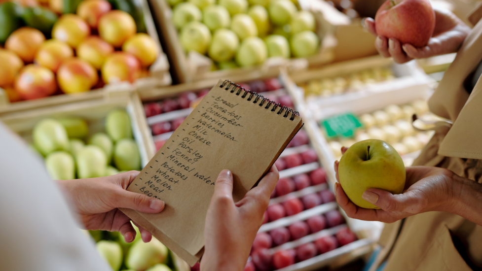 a person holding a shopping list in a supermarket