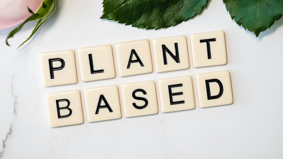 a close up of scrabble letters that says plant based