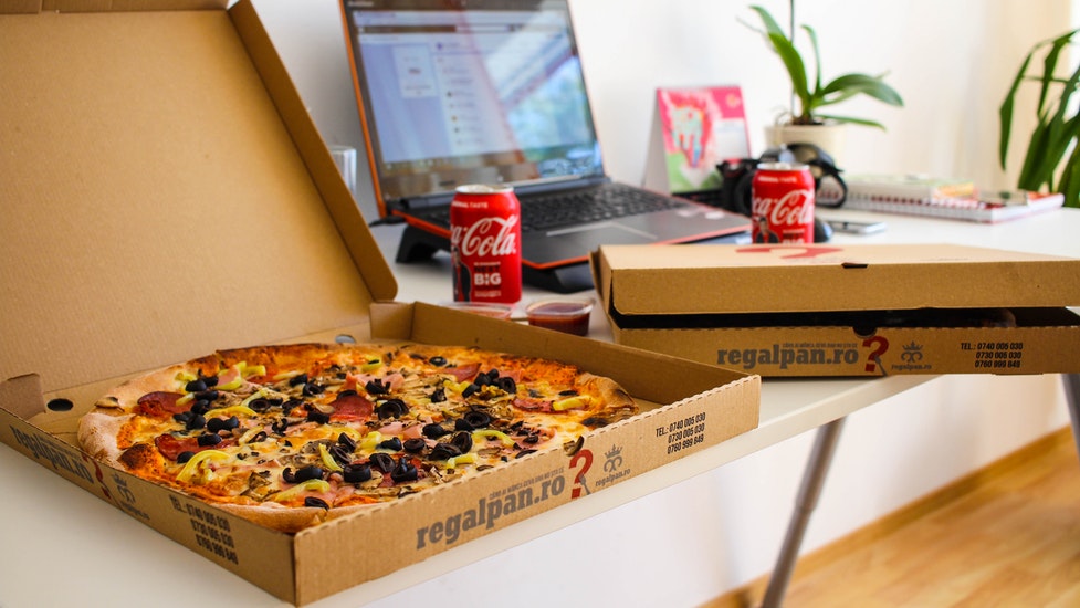 a box of pizza sitting on top of a table