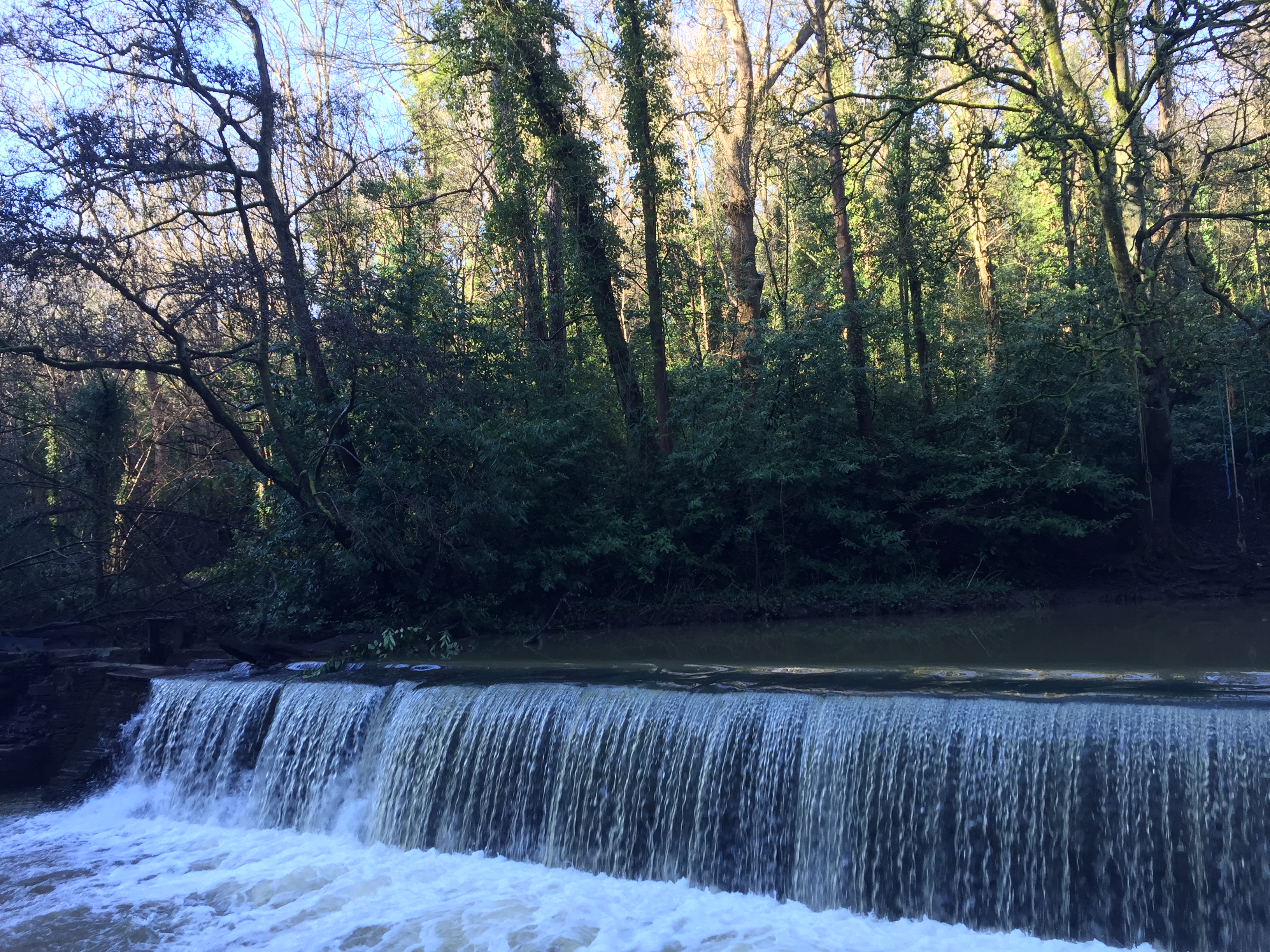 a waterfall going over a body of water