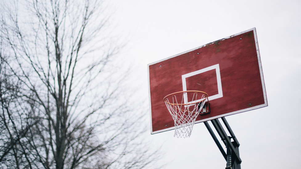 a basketball on a wooden pole