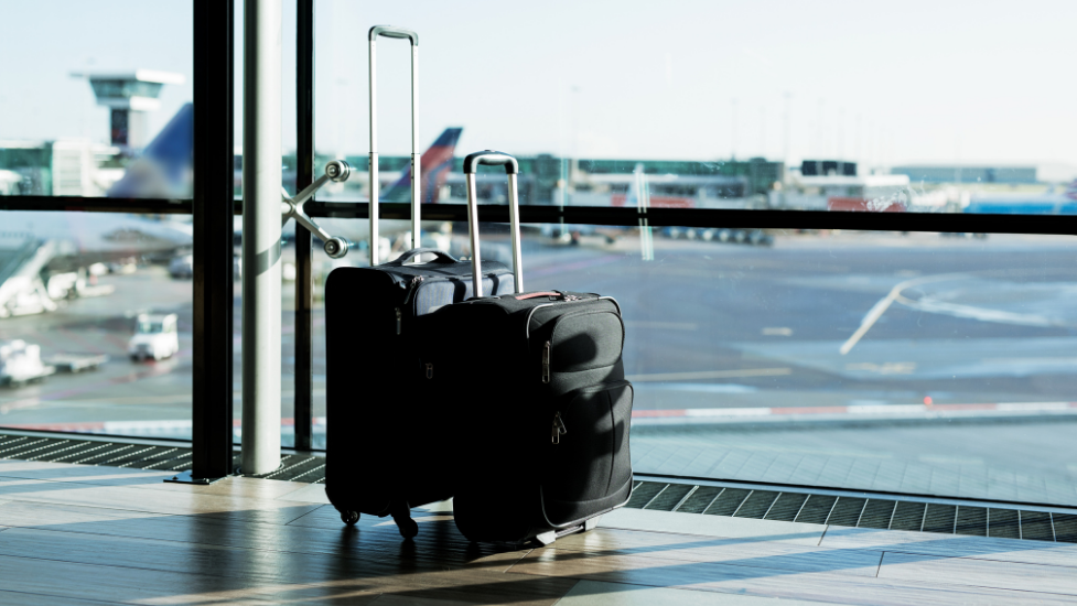 a suitcase infront of a window at an airport