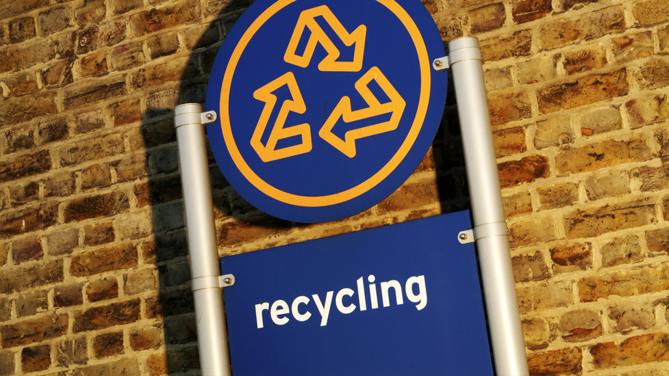 a blue sign in front of a brick building