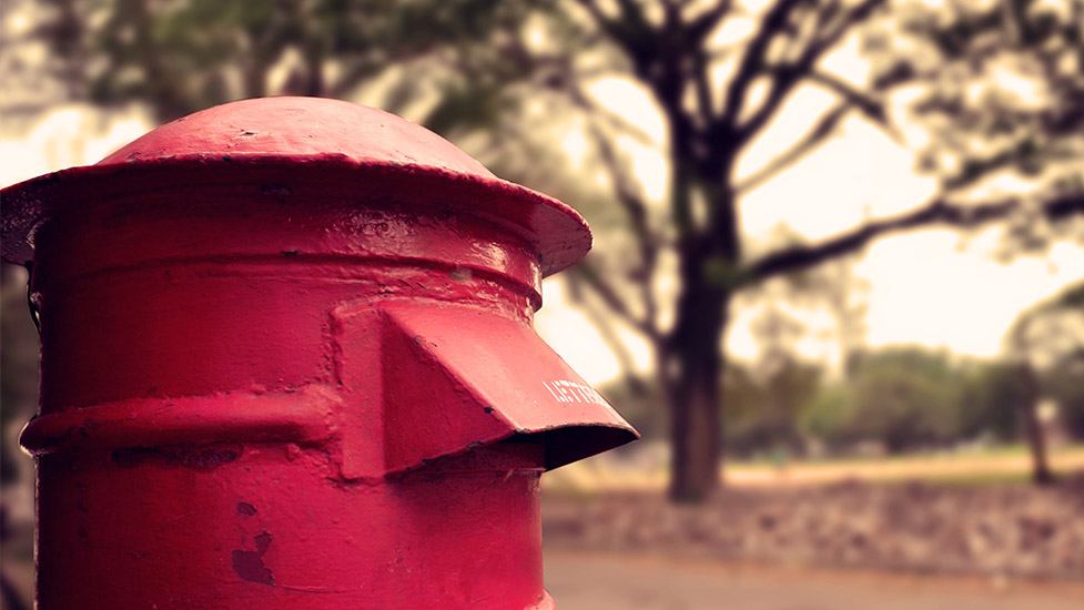 a close up of a red fire hydrant sitting on the side