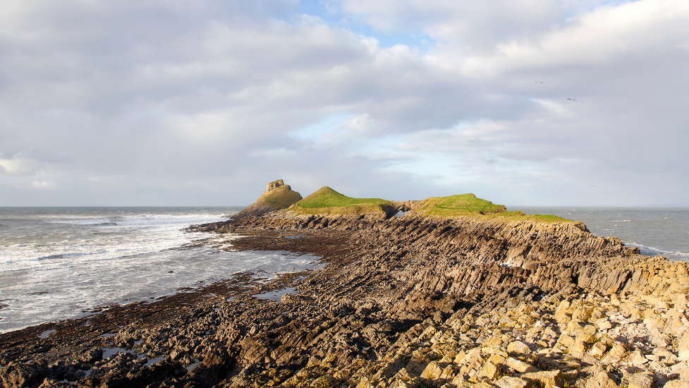 Worm's Head next to a body of water