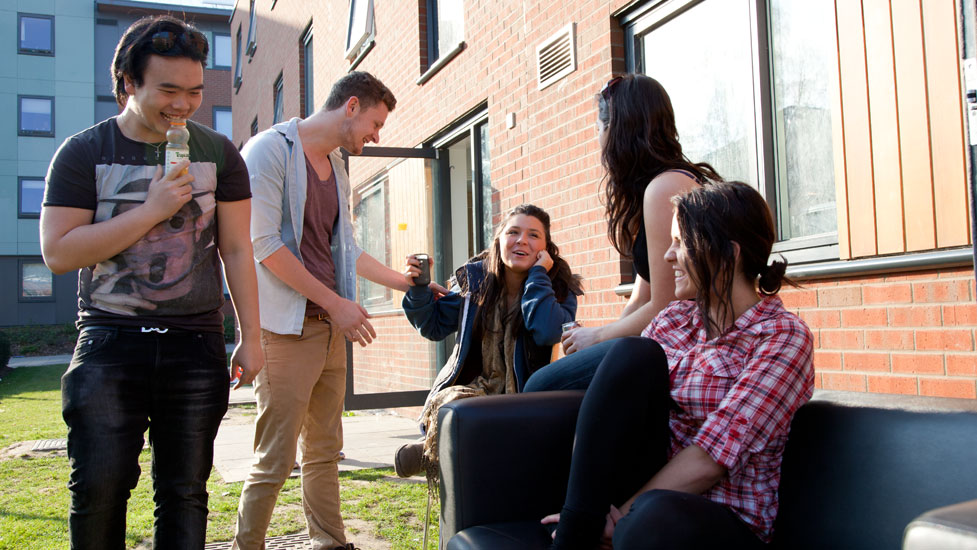 a group of people talking outside accommodation