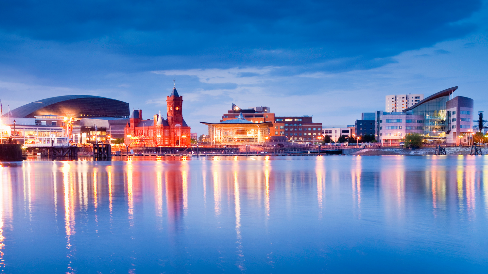 a large body of water with a city in the background