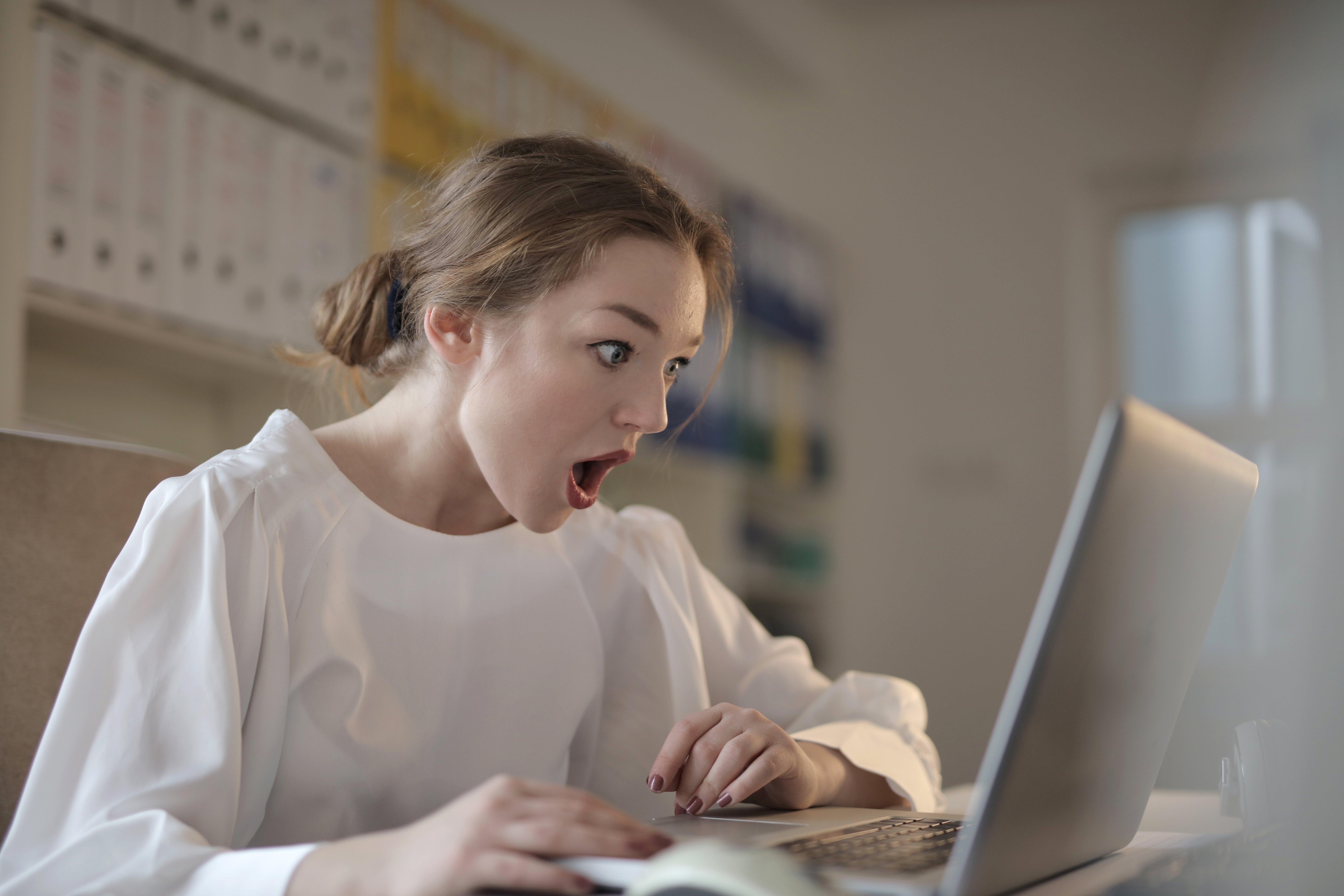 a person sitting at a table using a laptop