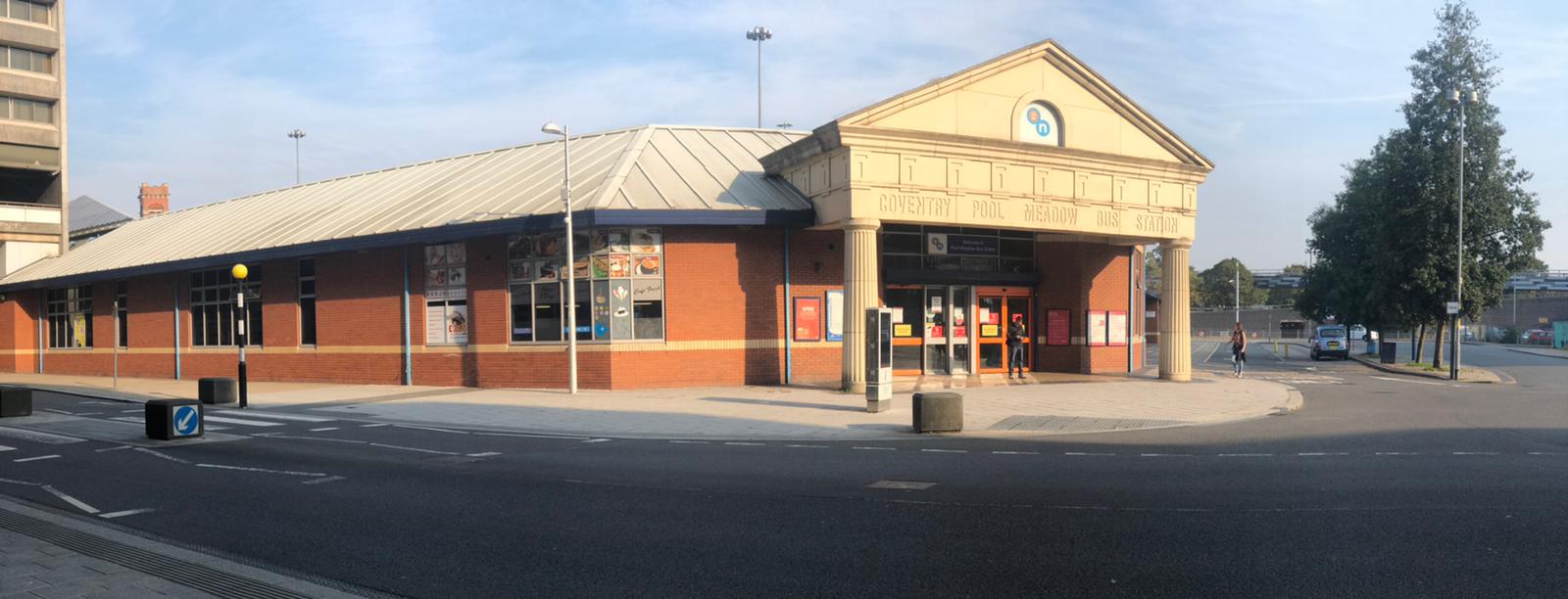 a building with a clock on the side of a road