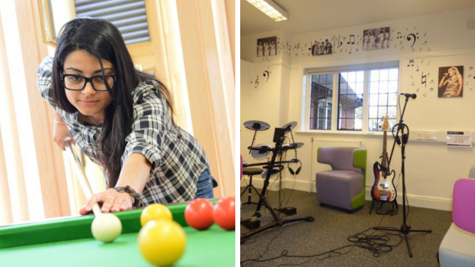 a woman sitting at a table with a ball in a room