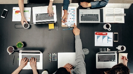 a group of people sitting at a desk